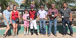 The winning connections of Dos Special Eye accept the Spring Fling Stakes trophy at Turf Paradise on Saturday.
