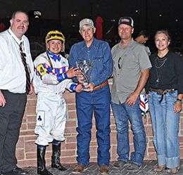 The winning connections of Uncle Redheads accept the Valley Junction Futurity-G3 trophy at Prairie Meadows on Friday.