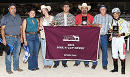 The winning connections of Action Required accept the $105,000 Sires' Cup Derby trophy at Retama Park on Saturday.