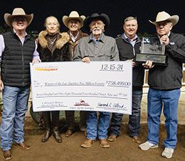 Ben Hudston presents the winning owners the Los Alamitos Two Million Futurity stakes trophy.