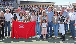 The winning connections of Deja Dulce accept the Wyoming Downs Futurity stakes trophy on Sunday afternoon.