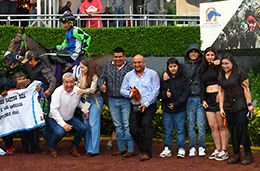 The winning connections of Dark Water Bay accept the Alredo Castro Rea Classic trophy at the Hipodromo de las Americas on Sunday.