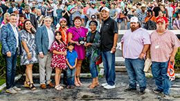 The winning connections of Apolitical Queen accept the $50,000 Flashy Hemp Stakes trophy at Delta Downs on Saturday.
