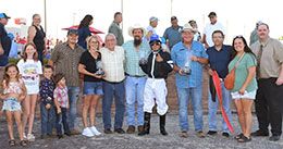 The winning connections of Prize Flyter accept the Jim Bader Futurity stakes trophy.