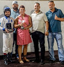 LQHBA Assistant Executive Director Misty Coats presents the winning connections of Marcy Train B the LQHBA Sale Debutante Stakes trophy at Delta Downs on Saturday.