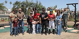 The winning connections of Cyber Buzz accept the $80,920 Desert Classic Futurity trophy at Turf Paradise on Monday.
