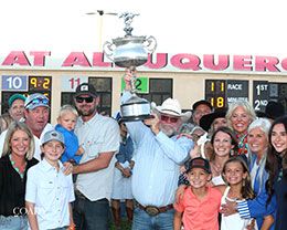 The winning connections of King Of The Tide with the 2025 All American Futurity stakes trophy.