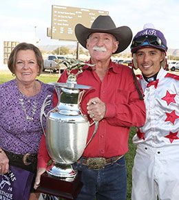 Winning owner John and Kathy Lee with jockey Adrian Ramos accept the New Mexico State Fair Futurity stakes trophy on Sunday.