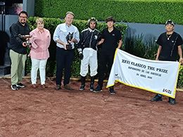 The winning connections of CCB Quorum accept the $32,700 The Prize Classic trophy at Hipodromo de las Americas on Sunday.
