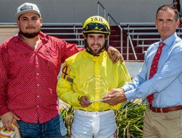 The winning connections of Moonin Princess accept the Treme Derby stakes trophy.