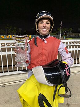 Justin Klaiber accepts trophy after winning the Miss Princess Handicap aboard Shaken Goin On at Los Alamitos on Sunday.