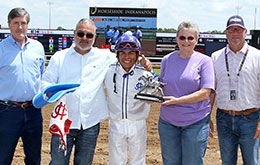 The winning connections of Caughtmeatagoodtime accept the Heartland Futurity stakes trophy.