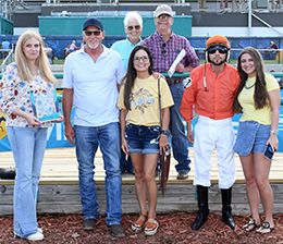 The winning connections of Gigis Gucci Glasses accept the Tulsa State Fair Stakes trophy at Fair Meadows on Saturday.