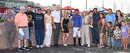 The winning connections of Ajs Favorite Ia accept the Cyclone Derby trophy at Prairie Meadows on Saturday.
