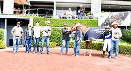 The winning connections of SE Carver Cruzan accept the $11,015 Gabriel Cue Sacre Classic trophy at Hipodromo de lasAmericas on Sunday.