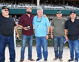 The winning connections of Wl Van Halen accept the Colors Of The Wind Paint & Appaloosa Maturity stakes trophy.