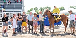 The winning connections of First Moon Cat accept the $8,000 Steel Etc Stakes (not black type) trophy at Great Falls on Saturday.
