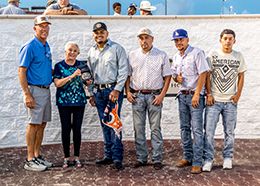 The winning connections of Konnan Cartel accept the Nag Nest Stakes trophy at Delta Downs on Saturday.