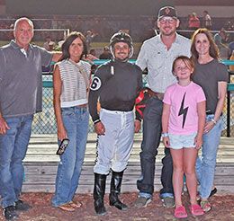 The winning connections of Cowboy On The Fly accept the Speedhorse Paint & Appaloosa Futurity stakes trophy Saturday night at Fair Meadows.
