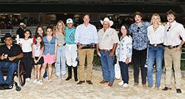 The winning connections of Ladys Gotta Jet accept the TQHA Sophomore Stakes trophy.