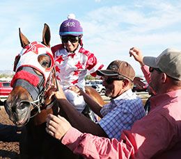 Winning jockey Adrian Ramos and trainer Wesley Giles with New Mexico State Fair Futurity winner Kj Bad Moon Rising.