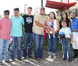 The winning connections of Bad King accept the First Moonflash Maturity stakes trophy at The Downs at Albuquerque.