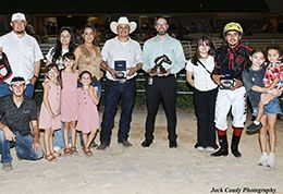 The winning connections of As Moonflash accept the AQHA Retama Park Championship Challenge stakes trophy on Friday.
