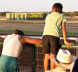 Many patrons enjoy the races at Gillispie from the rail.