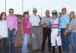 The winning connections of Imma Southern Bell accept the Iowa Stallion Futurity stakes trophy.