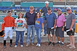 The winning connections of Fl Rizzo accept the $17,500 Walter Merrick Stakes trophy at Fair Meadows on Friday night.
