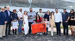 The winning connections of Full Moon Desire accept the John Deere Sam Houston Juvenile trophy on Saturday.