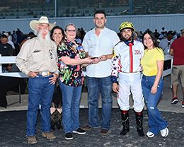 The winning connections of Hollywoode accept the $54,500 Willie Hickman Memorial Stakes trophy on Saturday at Sam Houston Race Park.
