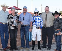 The winning connections of Five Bar Phi accept the Terrance Hill Stakes trophy.