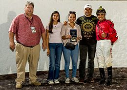 The winning connections of Konnan Cartel accept the $40,000 Titanium Stakes trophy at Delta Downs on Saturday.