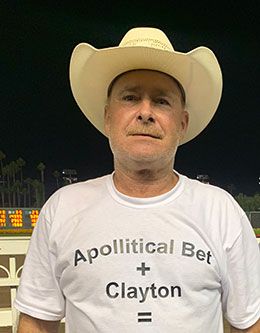Hobie Peterson wearing a custom-made t-shirt that read "Apollitical Bet + Clayton = $.".