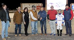The winning connections of Curls Joyful Wagon accept the Decektta Stakes trophy at Remington Park on Saturday night.em>