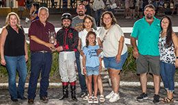 The winning connections of Reletless Politics accept the Firecracker Futurity stakes trophy.