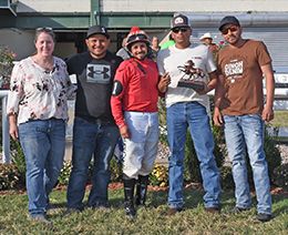 The winning connections of Shy Kisser accept the $24,000 Miss Ellen Stakes trophy at Will Rogers Downs on Sunday.
