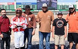 The winning connections of Luminozity accept the Colors Of Houston Juvenile Stakes trophy.