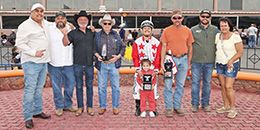 The winning connections of CQ Coyame Jessy accept the $80,000 NMHBA Stakes trophy at Sunland Park on Saturday.