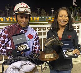 Jockey Ricardo Ramirez and trainer Kristen Watanabe accept the John Deere California Juveniel Challenge stakes trophies.