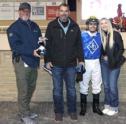 The winning connections of Relentless Coronado, including trainer Joe Davis, jockey Edwin Escobedo , and his wife Kaylee,accept the $56,160 Eastex Stakes [G2] trophy at Remington Park on Saturday.