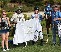 The winning connections of Runaway Fate accept the Ontario Sires Stakes Futurity trophy at Ajax Downs.