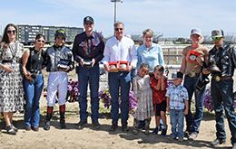 The winning connections of Jr Sakes Alive accept the Cox Ranch Energy Downs Distaff Challenge stakes trophy and buckles.