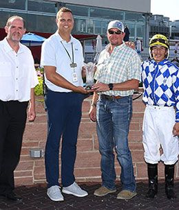 The winning connections of Fast Draw accept the Prairie Meadows Gold Derby stakes trophy.