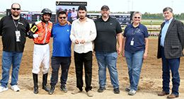 The winning connections of Tres Of Blood accept the $115,213 QHRAI Stallion Service Auction Derby trophy at Horseshoe Indianapolis on Saturday.