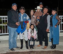 The winning connections of Cheap Bar accept the $98,500 Los Alamitos Maiden Stakes trophy at Los Alamitos on Sunday.