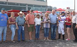 The winning connections of Lynnder 16 accept the Cox Ranch Prairie Meadows Distaff Challenge stakes trophy.