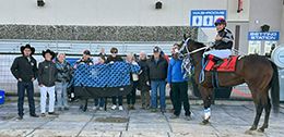 The winning connections of One Tough Cerveza accept the Alberta Bred Futurity trophy at Century Downs on Saturday.