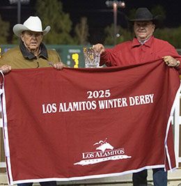 Robert and Ross Roark accept the Los Alamitos Winter Derby stakes trophy Saturday night at Los Alamitos Race Course.